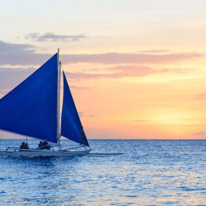 Sail,Boat,Against,Sunset,On,White,Beach,,Boracay,,Philippines